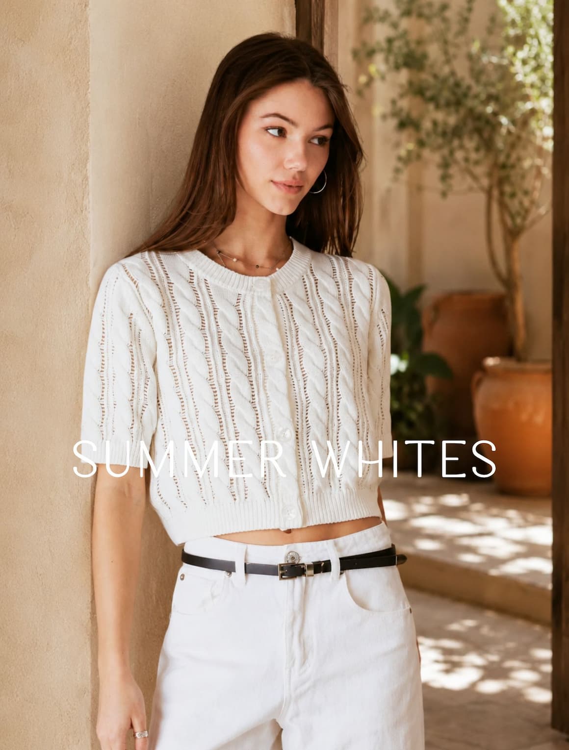 A lady wearing a white cotton short-sleeve cardigan.