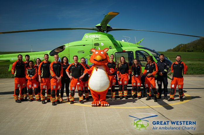 Photo of Zog the Dragon in front of a Great Western Air Ambulance with the real-life 'Flying Doctors'