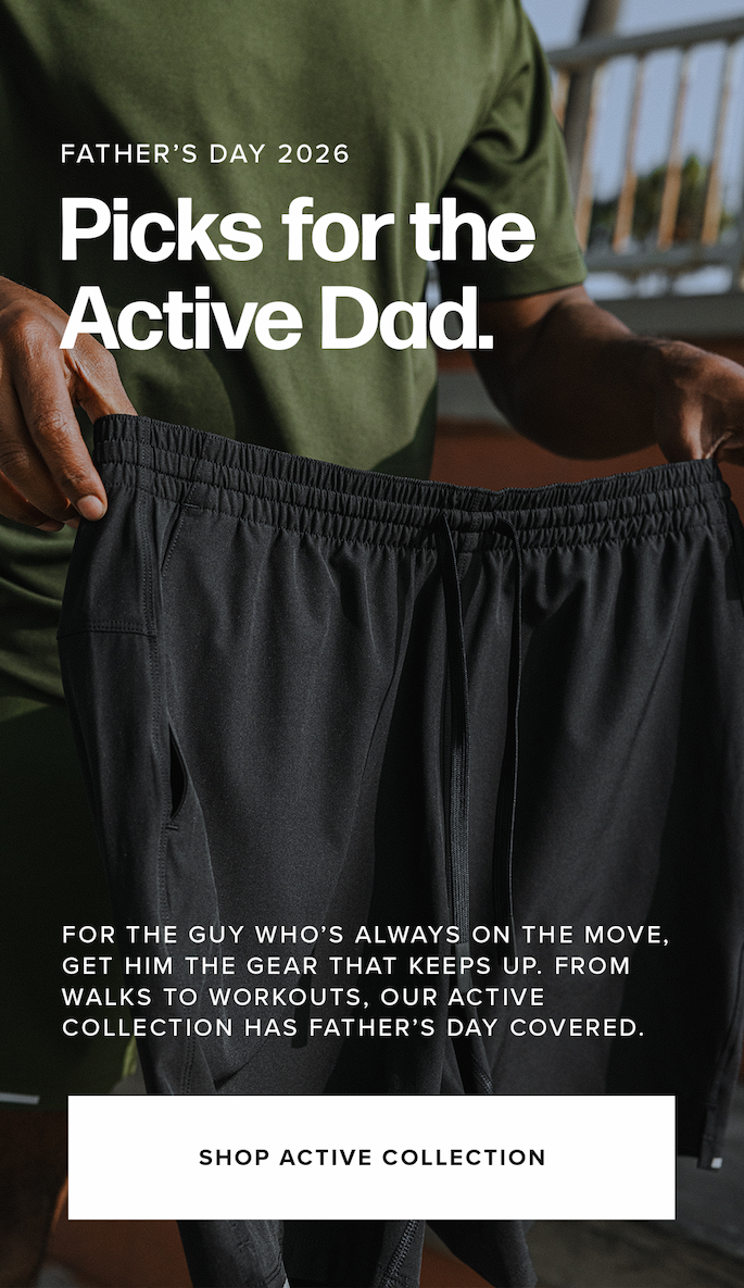A close-up shot shows a man wearing an olive green t-shirt while holding up a pair of black athletic shorts with a drawstring waistband. Text reads: 'Father’s Day 2026 Picks for the Active Dad... Shop active collection'