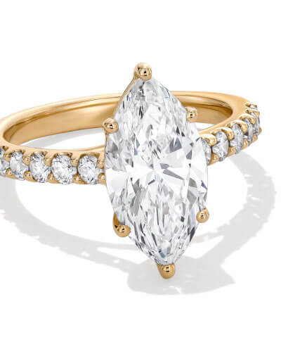 Yellow gold engagement ring with marquise-cut diamond center stone and pavé diamond band.