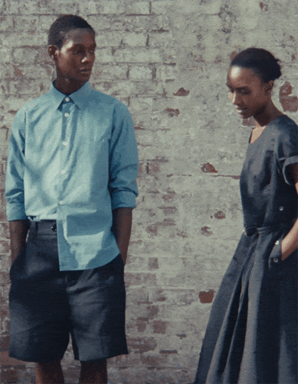 Relaxed summer tailoring and indigo workwear styled against a textured brick backdrop