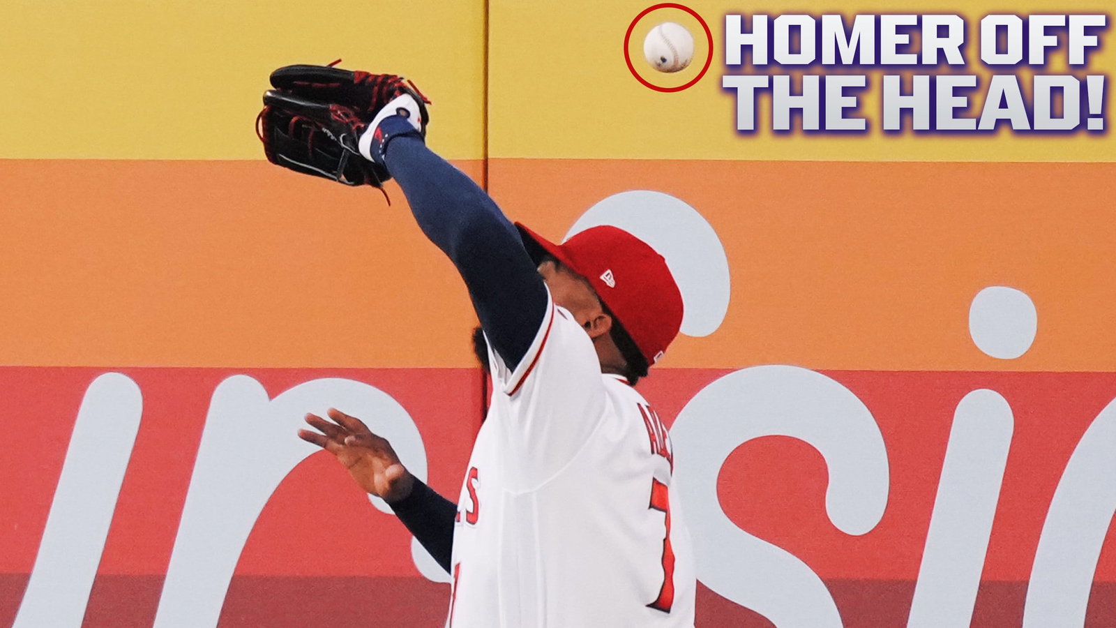 A fly ball bounces off of Jo Adell's head