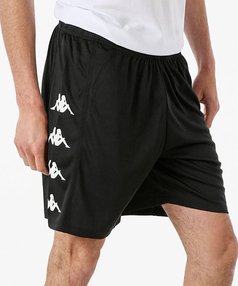 Black athletic shorts with white repeated side logo worn by male model, elastic waist and above-knee length