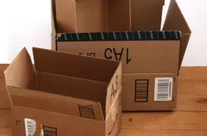 She cuts the lids off boxes, slathers them in glue & then she does this