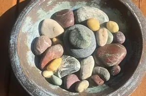 Stack some stones in an old dish or bowl for this quick way to improve your backyard