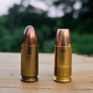FMJ and Hollow Point Ammo on table with trees in background