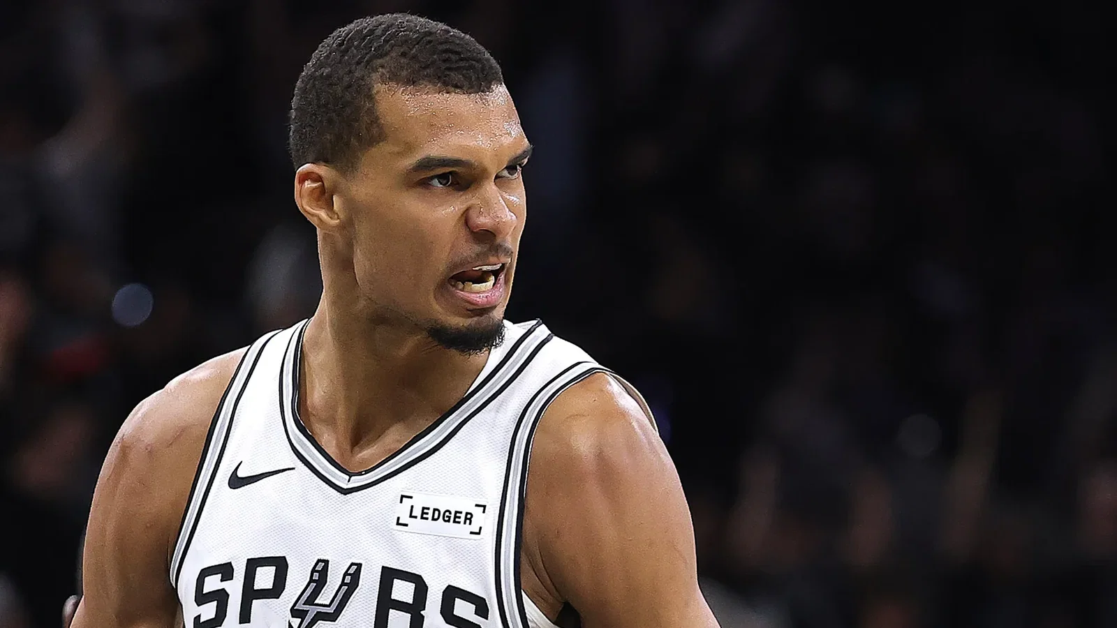 Victor Wembanyama makes a celebratory face during Game 4 of the Western Conference finals, wearing his white Spurs jersey.