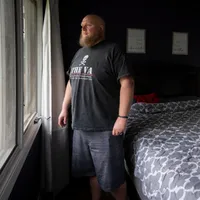 May 21, 2021; [ENTER CITY], IL, USA; Editor's Note: The subject's exact location has been redacted due to safety concerns.
May 21, 2021; Near Milwaukee, WI, USA. Daniel Berry, a former member of the Wisconsin chapter of the Proud Boys, looks out a window of his home for a portrait. Berry stays up each night to keep an eye on his home after receiving death threats for his plans to speak to USA TODAY. 

Upon joining the group, Berry thought it would be a friendly brotherhood of working men, but soon discovered a culture of relentless hazing and bullying within a thinly-veiled white supremacist organization.. Mandatory Credit: Jasper Colt-USA TODAY