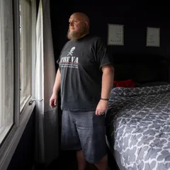 May 21, 2021; [ENTER CITY], IL, USA; Editor's Note: The subject's exact location has been redacted due to safety concerns.
May 21, 2021; Near Milwaukee, WI, USA. Daniel Berry, a former member of the Wisconsin chapter of the Proud Boys, looks out a window of his home for a portrait. Berry stays up each night to keep an eye on his home after receiving death threats for his plans to speak to USA TODAY. 

Upon joining the group, Berry thought it would be a friendly brotherhood of working men, but soon discovered a culture of relentless hazing and bullying within a thinly-veiled white supremacist organization.. Mandatory Credit: Jasper Colt-USA TODAY