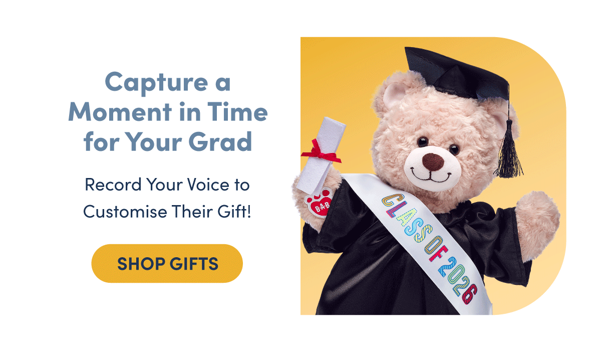 Light neutral background with bold headline text on the left and a graduation scene on the right. A plush teddy bear wears a black graduation cap and gown with a white sash reading Class of 2026 and holds a rolled diploma tied with a red ribbon, posed against a soft blue backdrop. | Text reads: Gifts for the Class of 2026 | Record Your Voice to customise their gift! | SHOP GIFTS