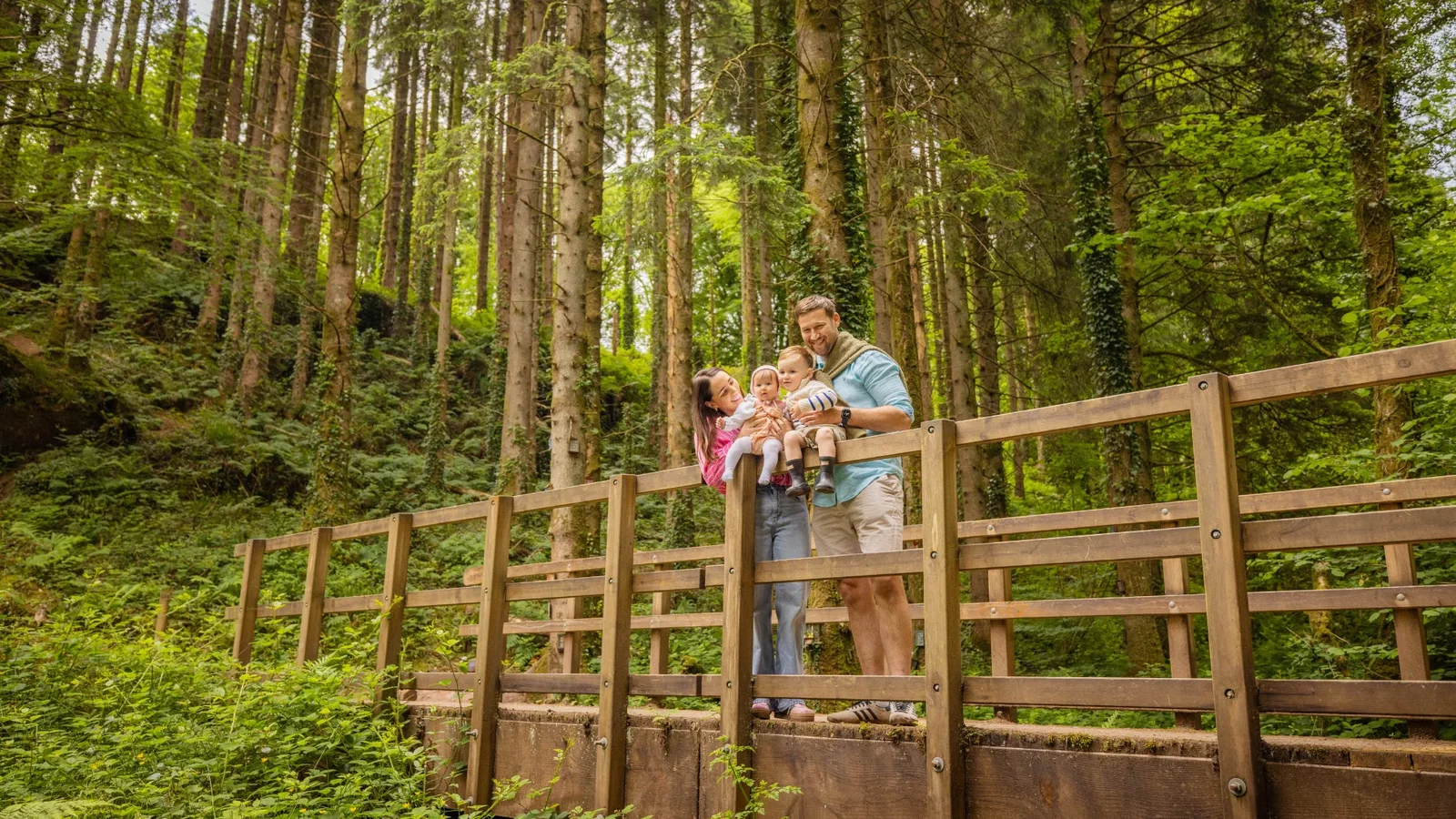 Family smiling looking at the woodland in Bluestone's forest