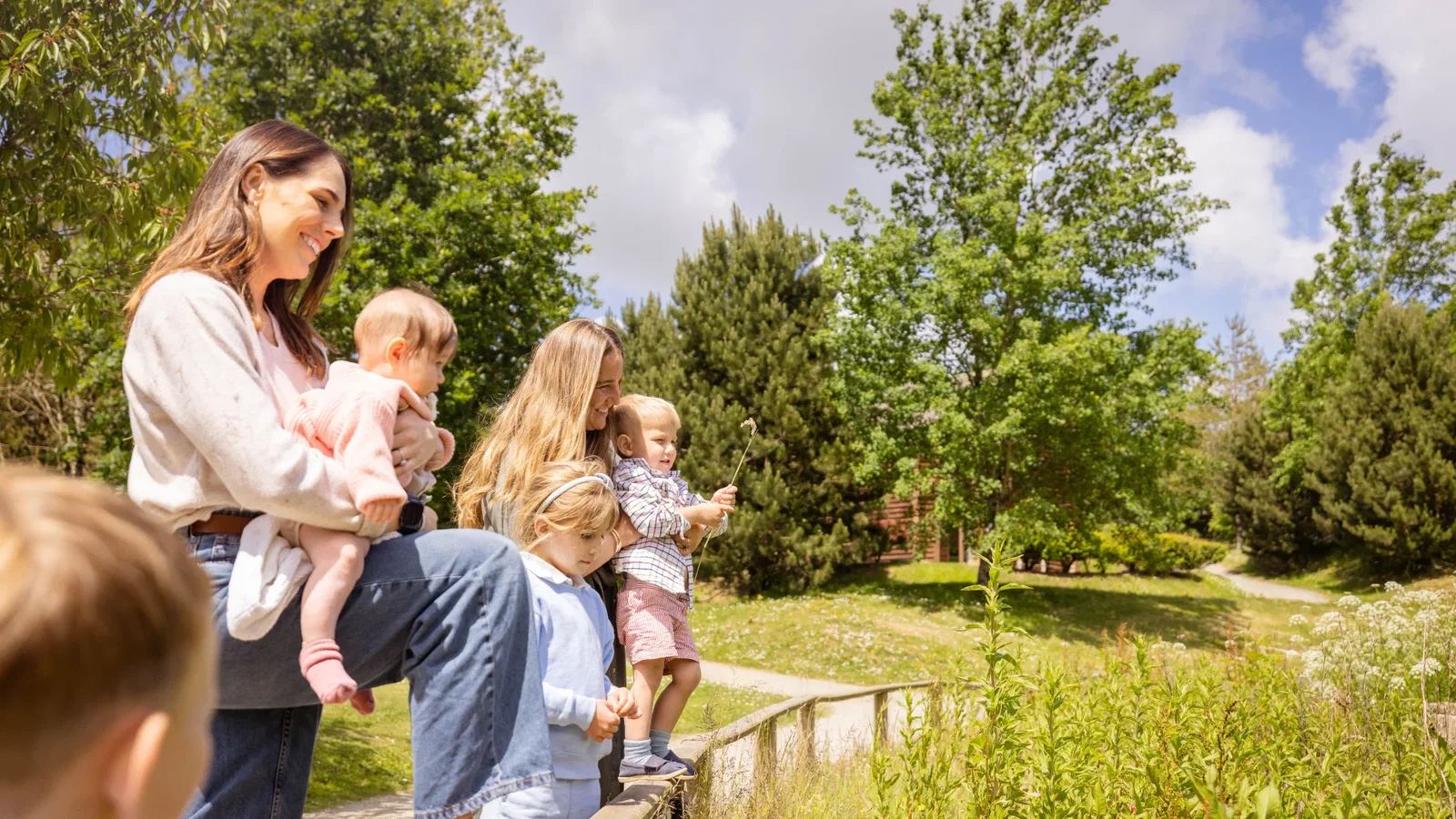 Family looking happy next to Bluestone's lake