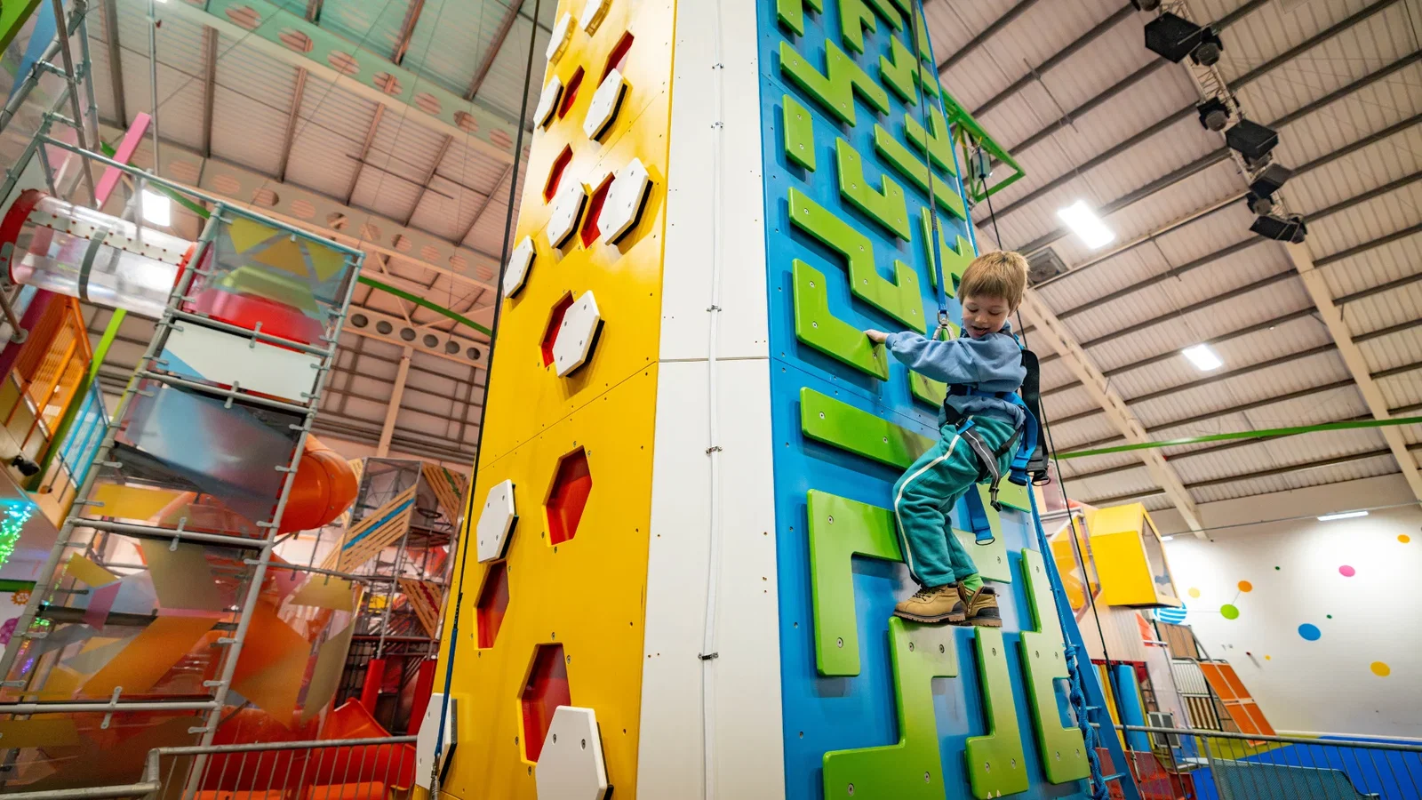 Child climbing the climbing tower at the hive