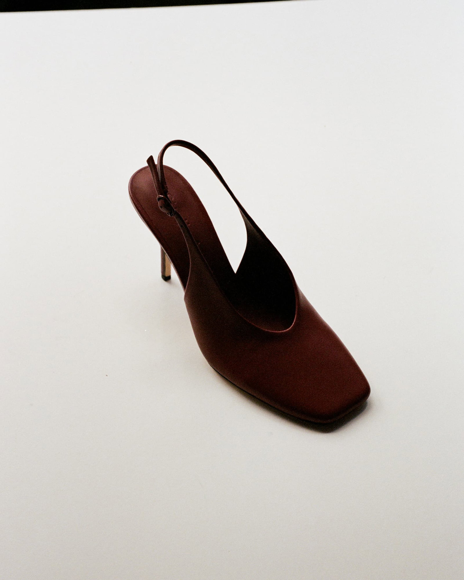 A red leather pump with a slingback style