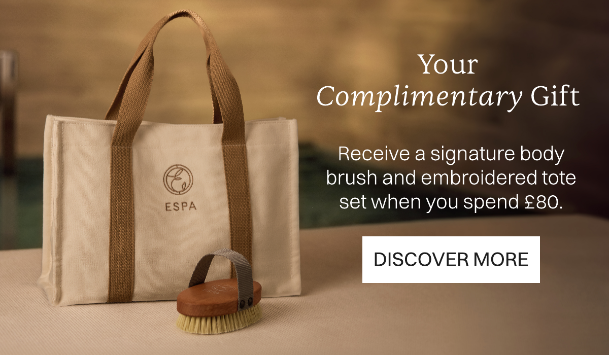 Image of Tote Bag and Body Brush. Text: Your complimentary gift. Receive a signature body brush and embroidered tote bag when you spend £80. SHOP NOW