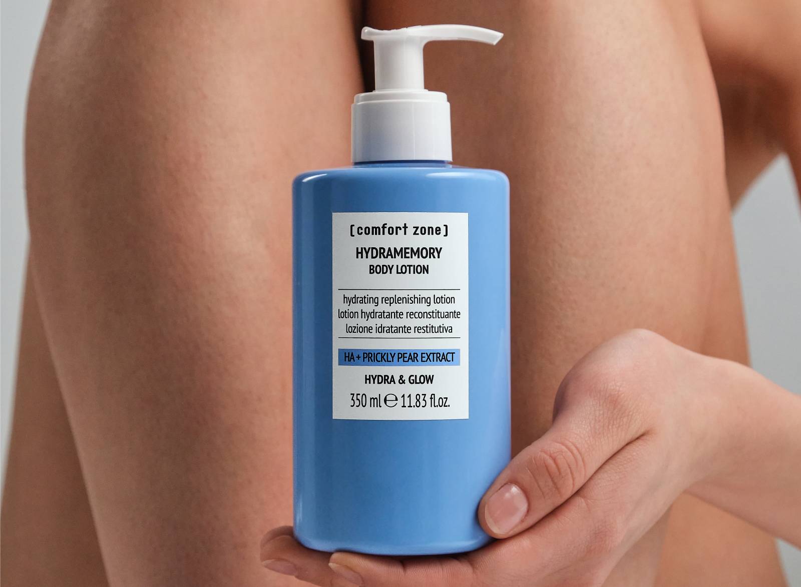 Woman holding Hydramemory Body Lotion next to her legs