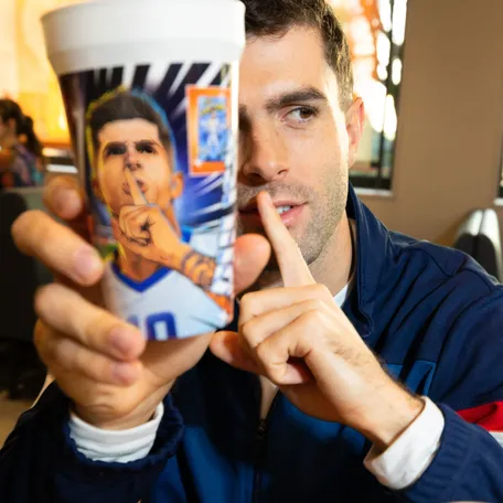 A handout image of USMNT star Christian Pulisic holding a collectable cup that is included in the McDonald's FIFA World Cup 26 Meal.