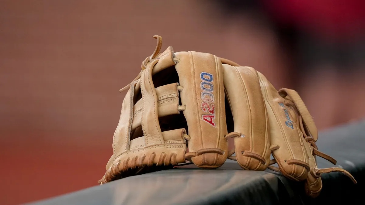 May 29, 2026; Tuscaloosa, AL, USA; The glove belonging to Alabama third baseman Jason Torres (32) sits on the dugout ledge as the team warms up before the Tuscaloosa NCAA Regional baseball game between Alabama and Alabama State in Sewell-Thomas Stadium.
