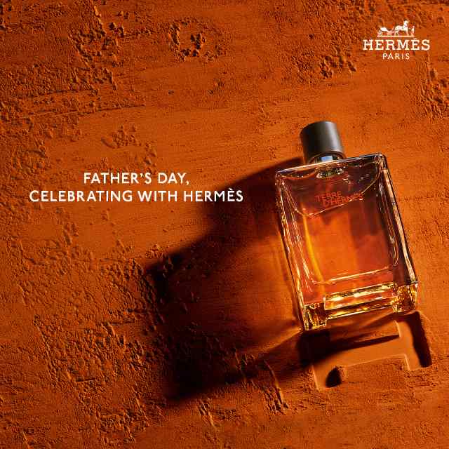 Hermès perfume bottle on textured orange background with text: 'Father's Day, Celebrating with Hermès.'