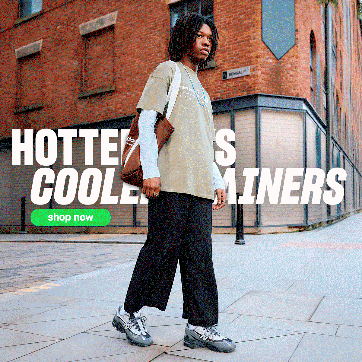 A hero image featuirng a man wearing New Balance black 1000 with text stating 'Hotter Days Cooler trainers 