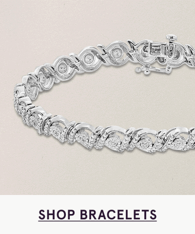 Silver-toned tennis bracelet composed of linked circular settings. Click here to shop bracelets