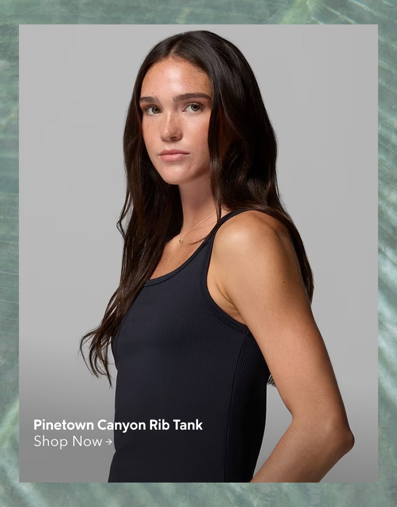 A woman wearing a black tank top with text: Pinetown Canyon Rib Tank Shop Now