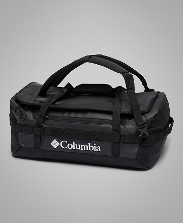 A grey and black duffel bag against a grey background.