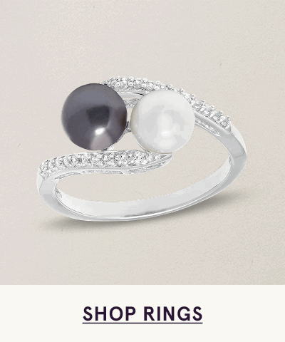 Silver bypass-style ring with two pearls: black & white, set against diamond-accented bands. Click here to shop rings