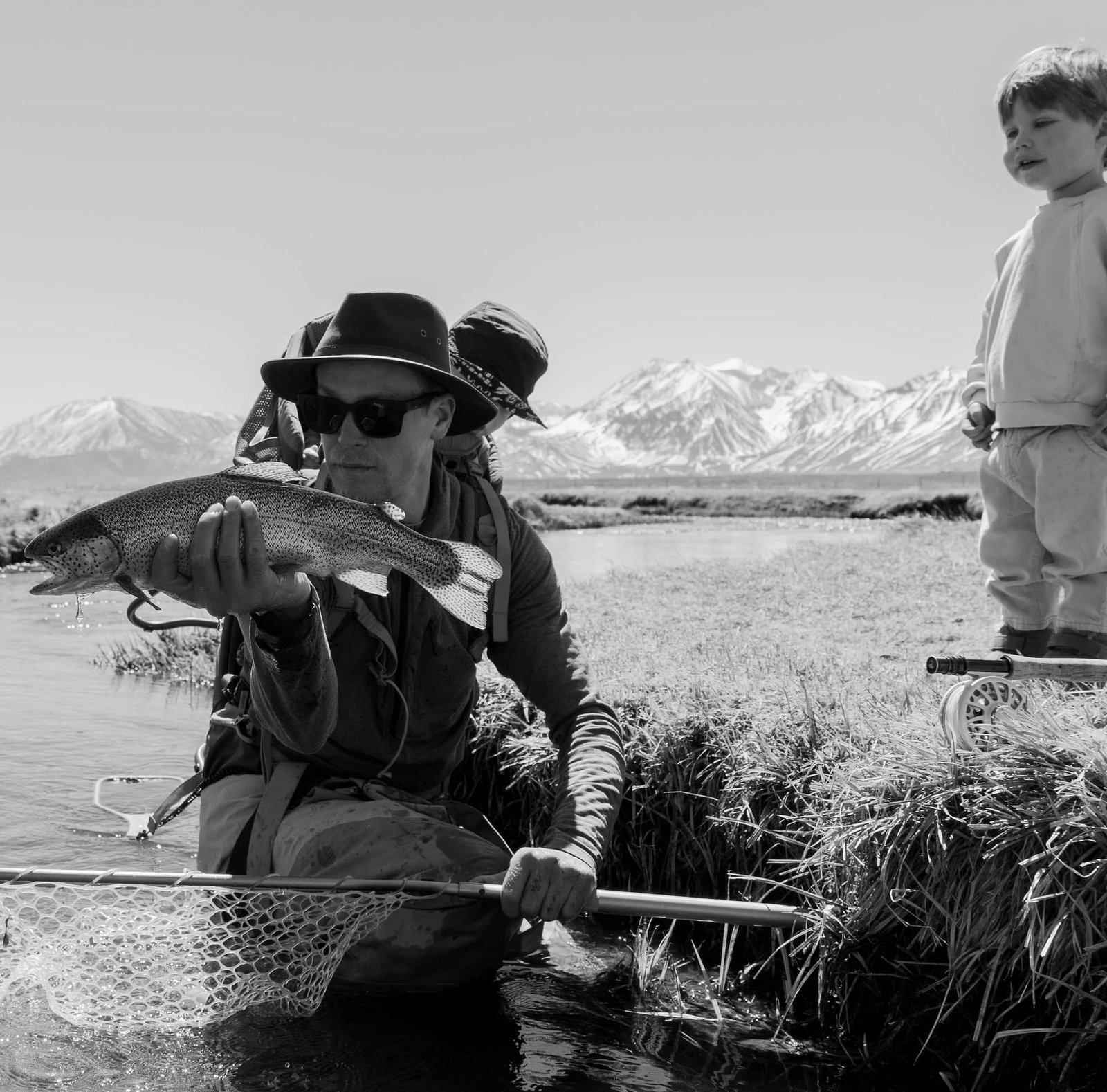 a dad fishing with his sons