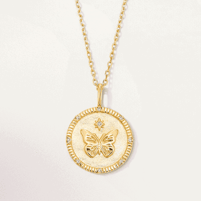 A gold necklace with a butterfly medallion.