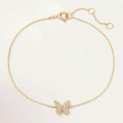 A gold bracelet with a diamond butterfly.