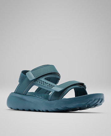 A dark blue sandal against a grey background.