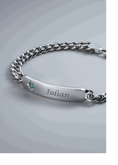 Silver curb chain ID bracelet engraved with Julian and green birthstone star accent.
