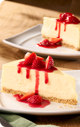 Slice of Sicilian Cheesecake topped with strawberries, celebrating National Cheese Day at Olive Garden.