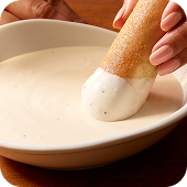 Creamy Olive Garden Alfredo Dipping Sauce served alongside warm appetizers.