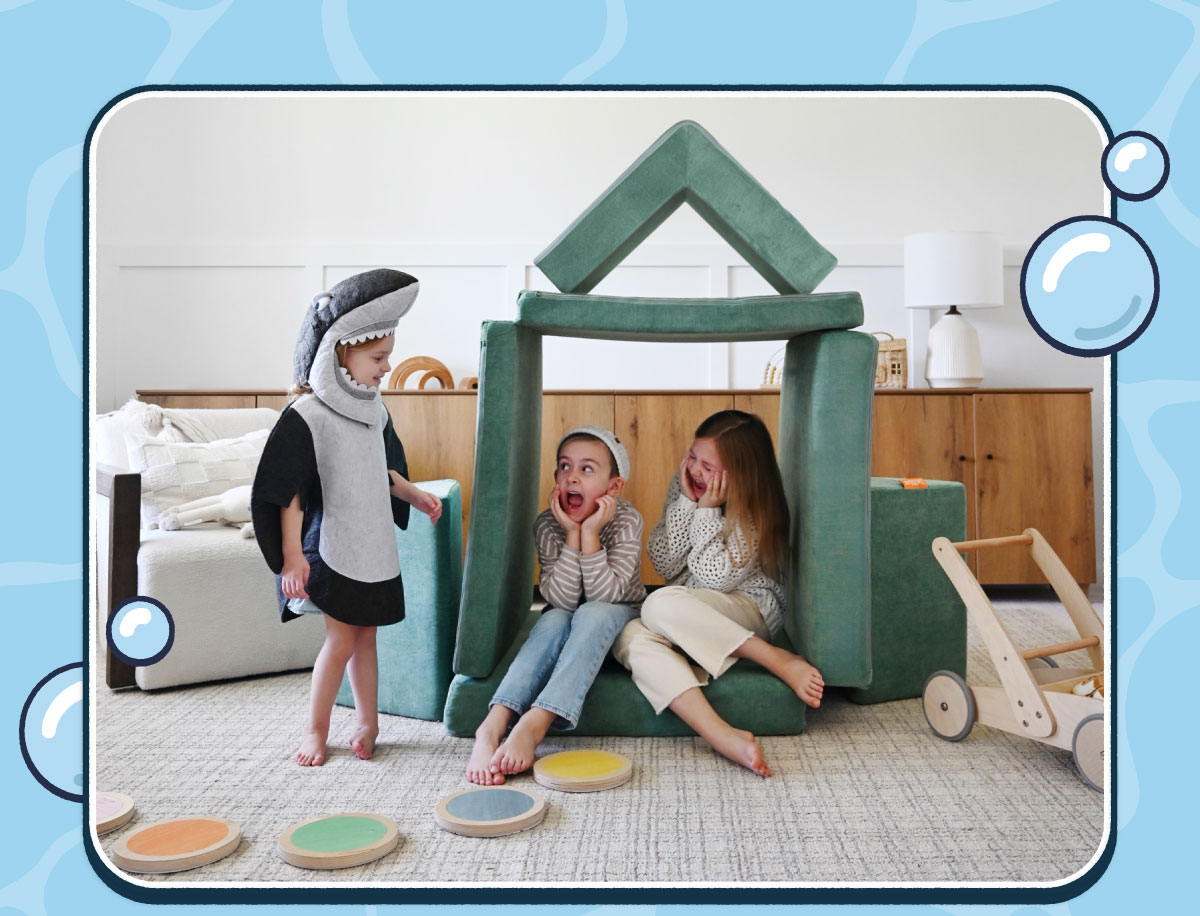 Three children play in a build made from Seamonster Nugget Play Furniture. 