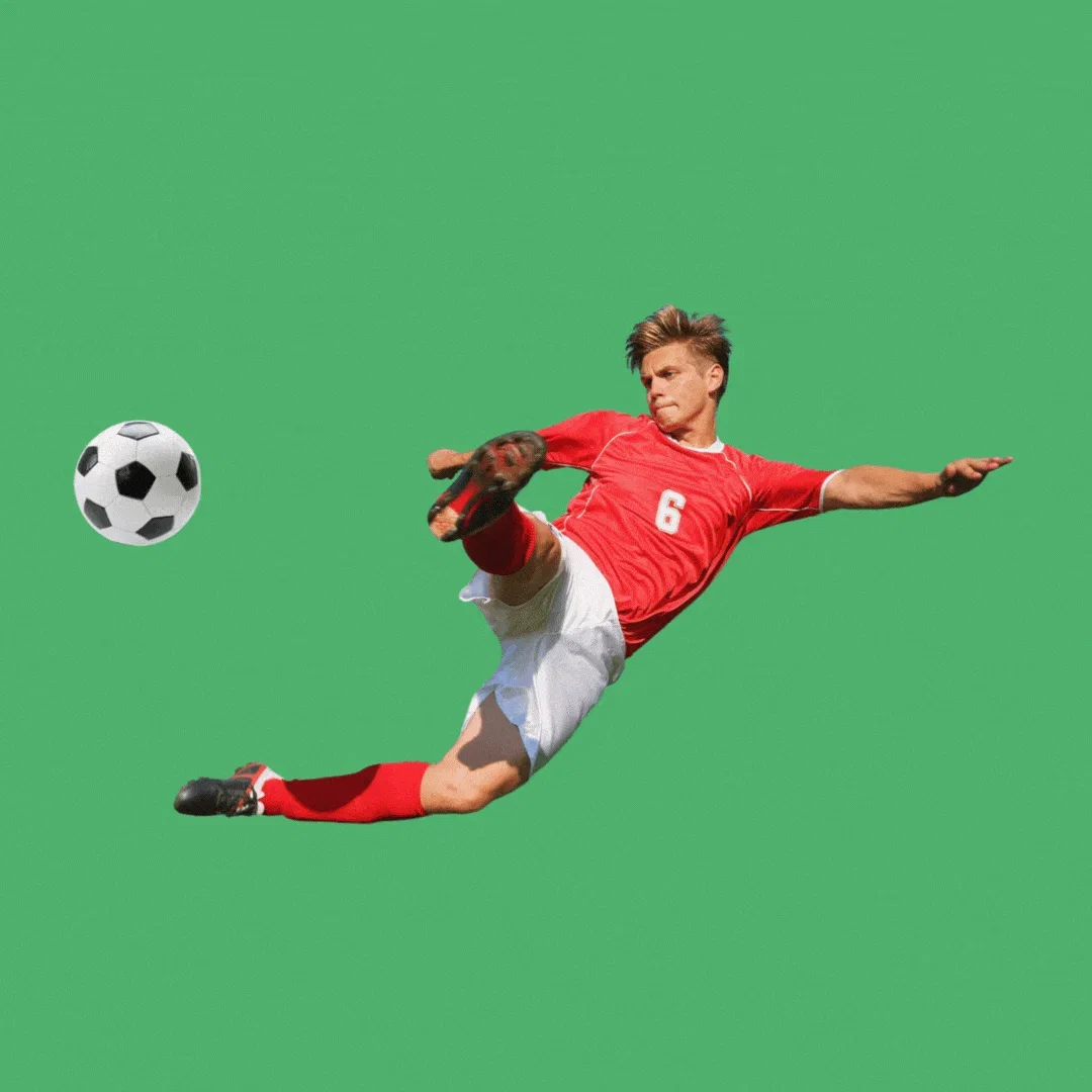 A soccer player kicking a ball. 