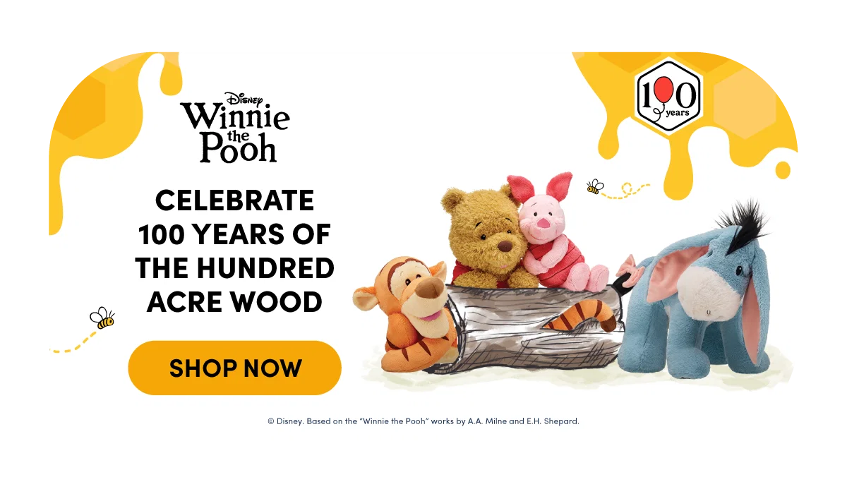 Bright honey-yellow layout with dripping honey accents and illustrations of bees framing a Disney Winnie the Pooh scene. Winnie the Pooh and Piglet sit together inside a hollow log with Tigger leaning nearby and Eeyore standing to the side, all plush characters grouped on a soft neutral background. A 100 years badge appears in the corner.Text reads: Disney Winnie the PoohCELEBRATE 100 YEARS OF THE HUNDRED ACRE WOODSHOP NOW