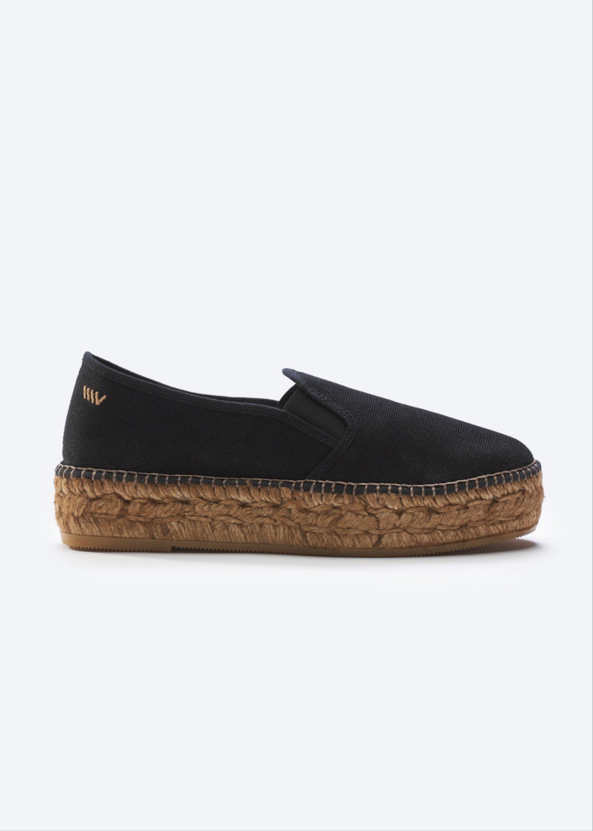 Black canvas platform espadrille flat with braided jute sole and slip-on silhouette for effortless coastal style
