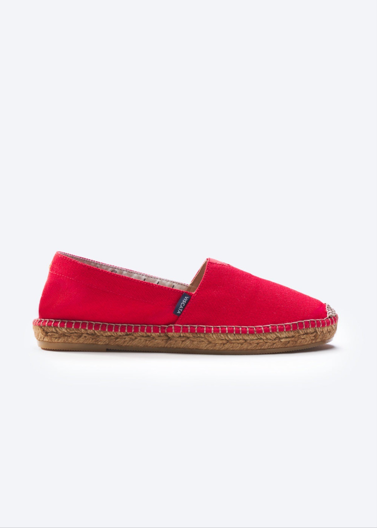 Red canvas espadrille flat with woven jute sole, slip-on silhouette, and easy Mediterranean summer charm