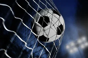 A soccer ball hitting the back of the goal's net