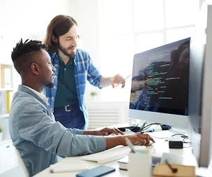 image-two-people-reviewing-code-on-screen