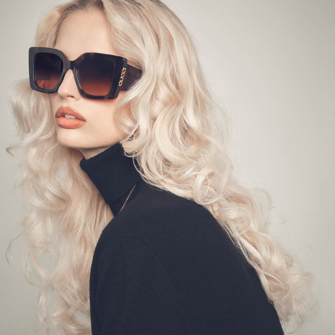 Person wearing Gucci sunglasses