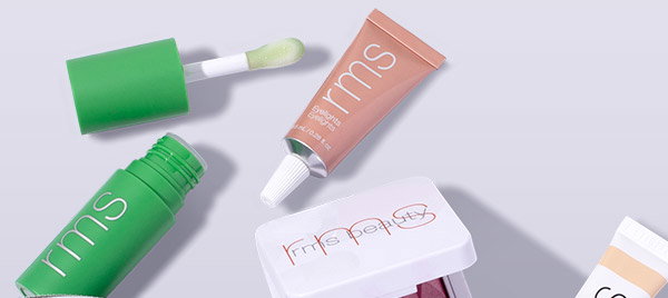RMS Beauty products coming out of a makeup bag