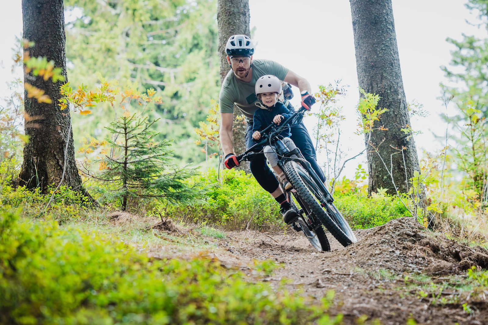 Dad and son riding bike dirt trail