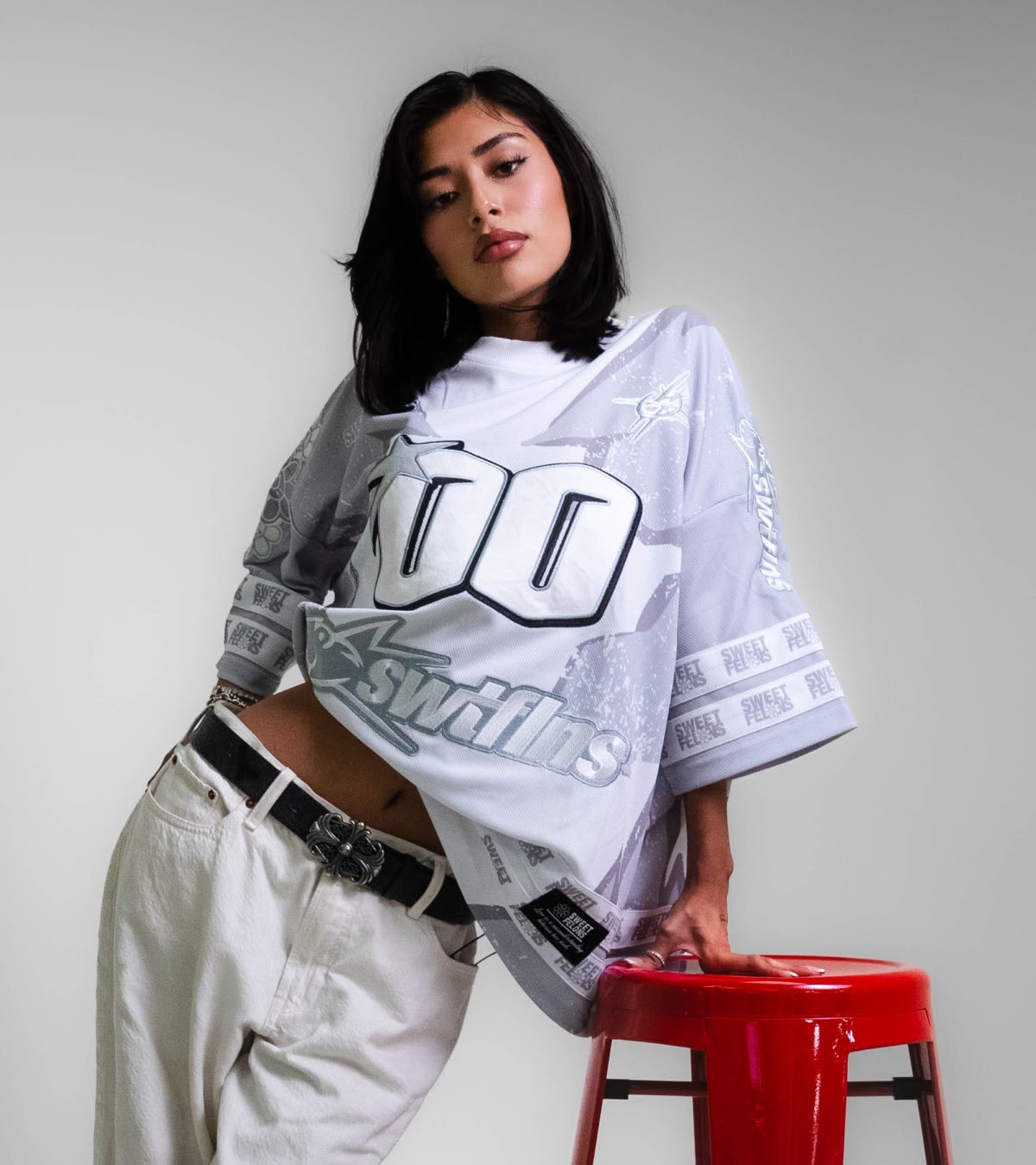 Shop Sweet Felons | A woman wearing the white jersey, now available online