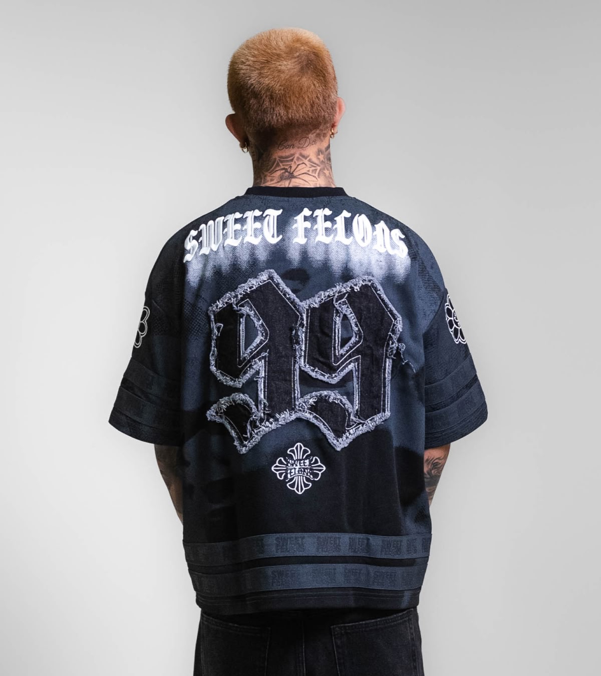 Shop Sweet Felons | A man wearing the black jersey, now available online