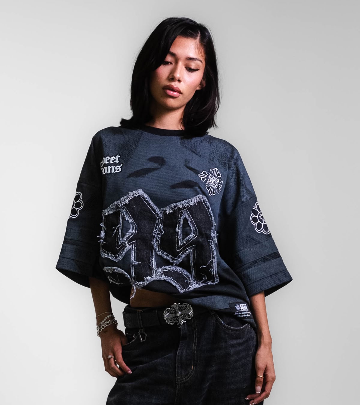 Shop Sweet Felons | A woman wearing the black jersey, now available online