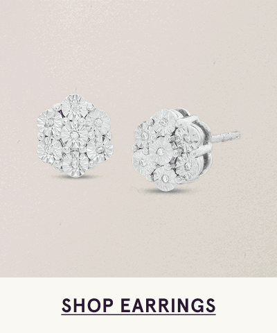 Pair of diamond cluster studs designed in a hexagonal flower-like shape. Click here to shop earrings