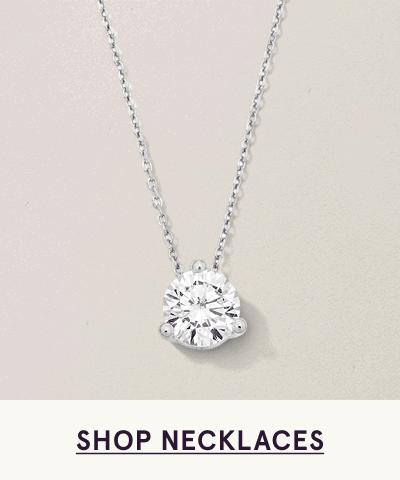 Single round-cut diamond solitaire pendant on delicate cable chain. Click here to shop necklaces